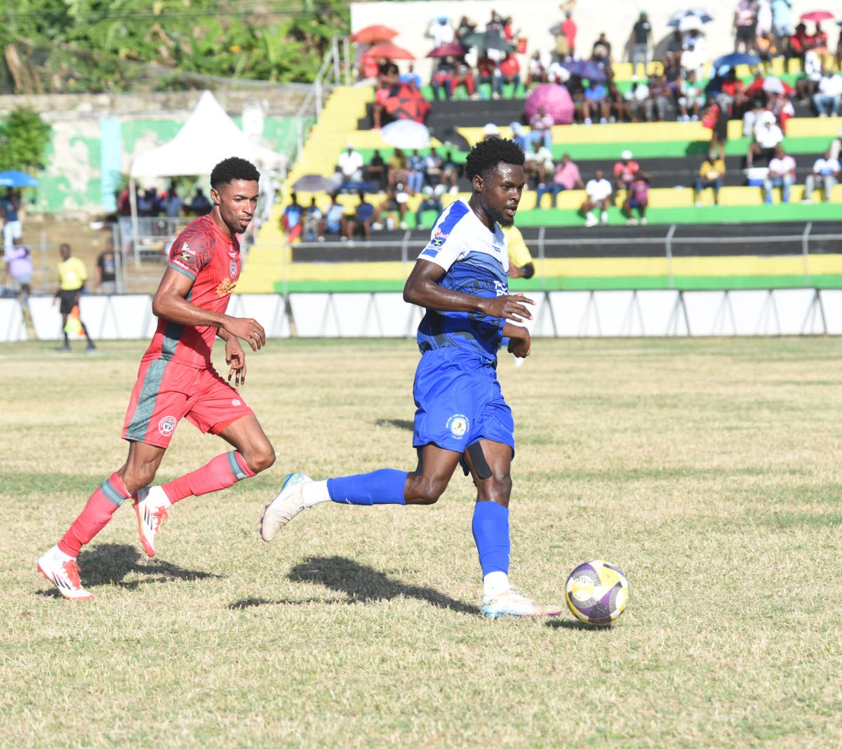 Mount Pleasant Football Academy’s Kyle Ming (right) tries to outrun Montego Bay United’s Timar Lewis during their Jamaica Premier League game at Jarrett Park on Sunday. Mount Pleasant won 1-0.