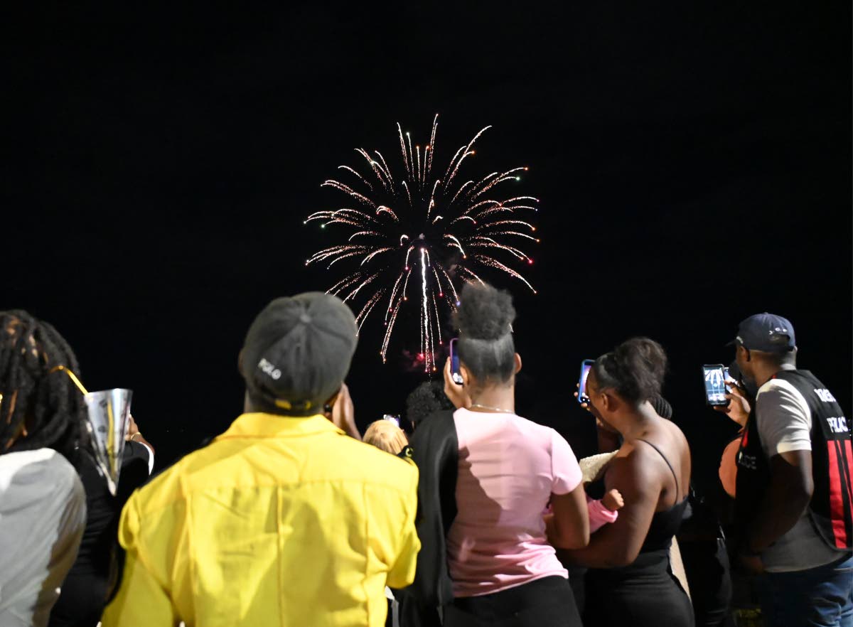 Residents watch fireworks light up Black River’s seafront in St Elizabeth for the first time during the UDC’s New Year’s show.