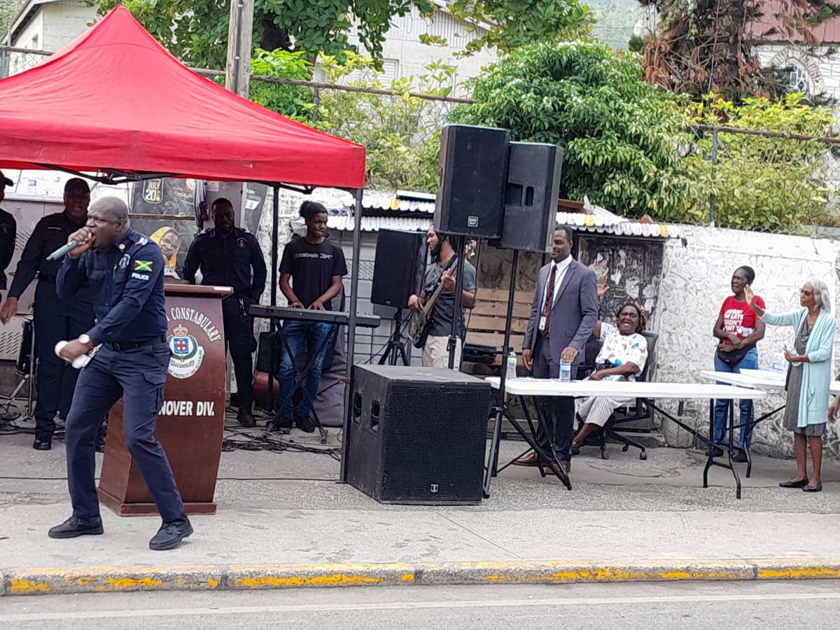 Police Corporal Marlando Gordon (left) delivers the main message at the Jamaica Constabulary Force Hanover Division Community Praise and Worship, held in the town square in Hopewell.