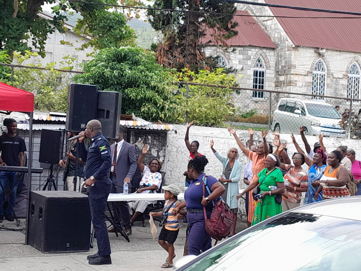 ‘Lift your hands and praise Him’ seems to be the command from Police Corporal Marlando Gordon as he gets the crowd moving during the Jamaica Constabulary Force Hanover Division Community Praise and Worship, held in the town square in Hopewell.