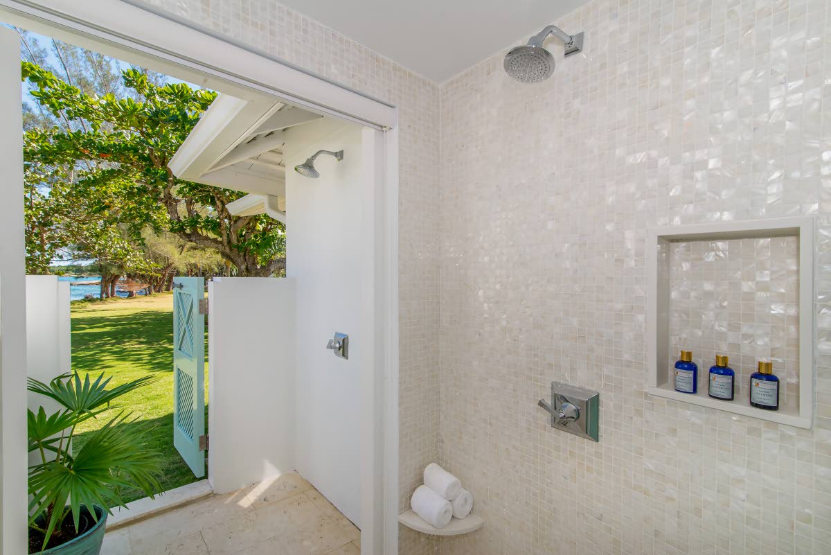 All bathrooms are air-conditioned. This one showcases the walk-in, indoor-outdoor open-air rain showers.