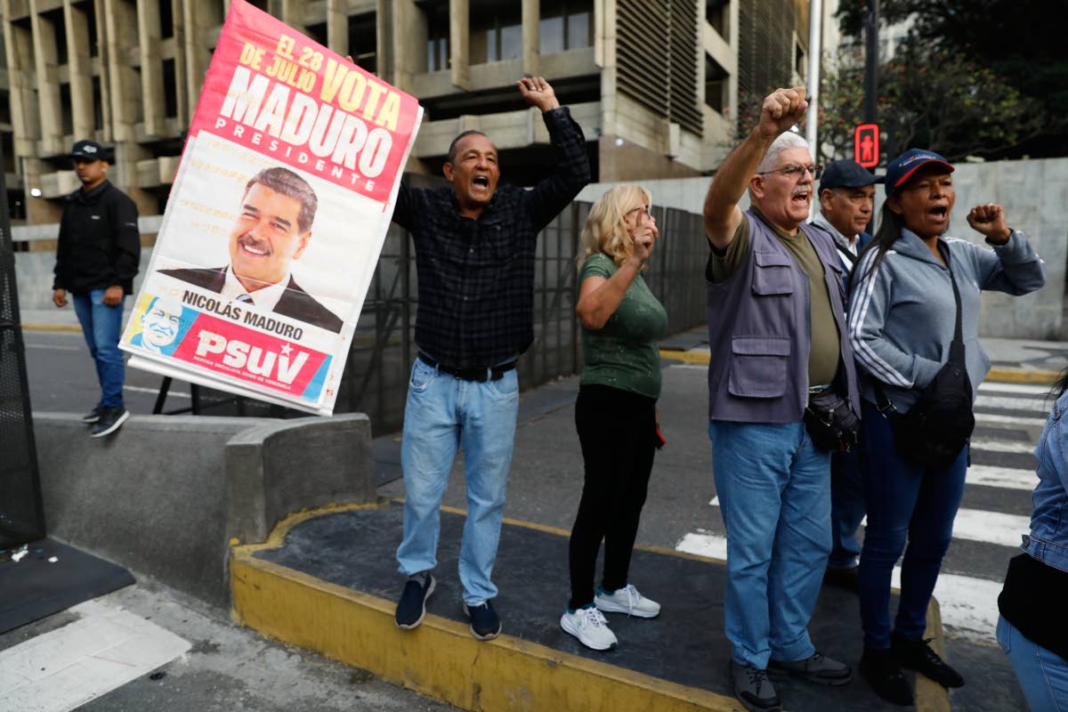 Supporters display a poster of Venezuelan President Nicolás Maduro in Caracas, after US President Donald Trump announced Maduro had been captured and flown out of the country.