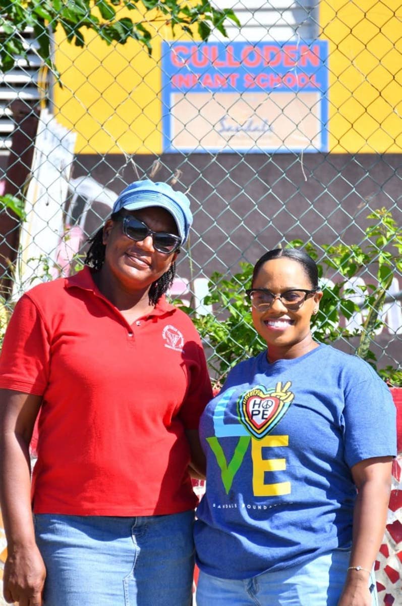 Principal of Culloden Infant, Michelle Whittingham (left) and Sandals Foundation Public Relations Administrator Alexis Gayle Grant, share a smile as modular classrooms are delivered.