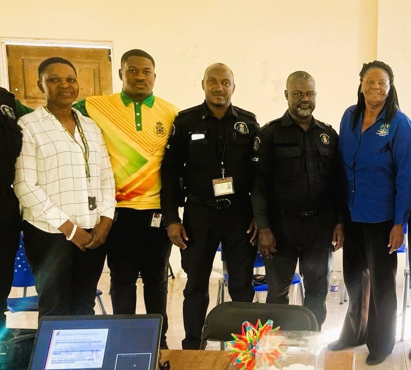 Dr Grace Kelly (right), Northern Caribbean University psychologist, poses with members of the Manchester Police Division after conducting a session on psychological first aid. 