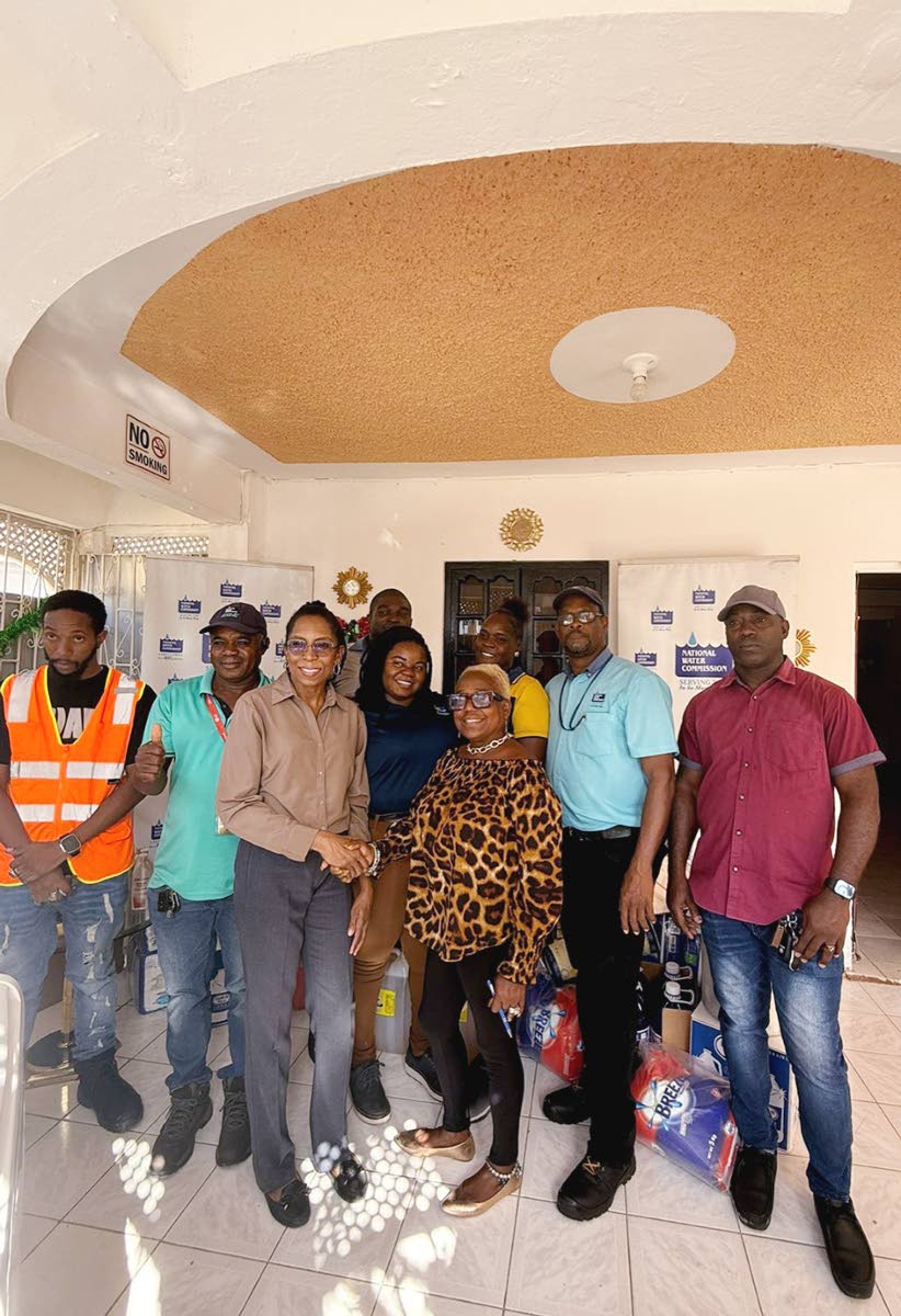 Representatives of the National Water Commission’s maintenance team (eastern) along with Acting Community Relations Manager (eastern) Ann Bolt (third from left), during the handover of donated items to Sandy Frazer-Jackson, manager of the Ultimate Care C