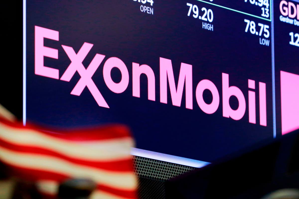 The logo for ExxonMobil appears above a trading post on the floor of the New York Stock Exchange, April 23, 2018. (AP Photo)
