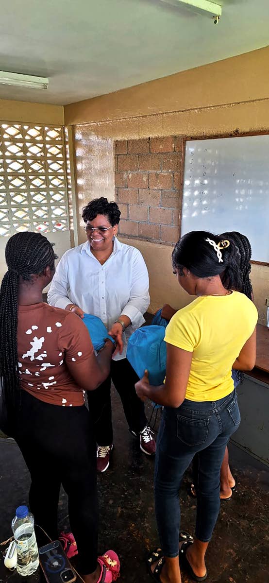Dr Marsha Smith, with a few of the young adults following the Bahali Hurricane Melissa Recovery Project hosted by the Newell High School in St Elizabeth.