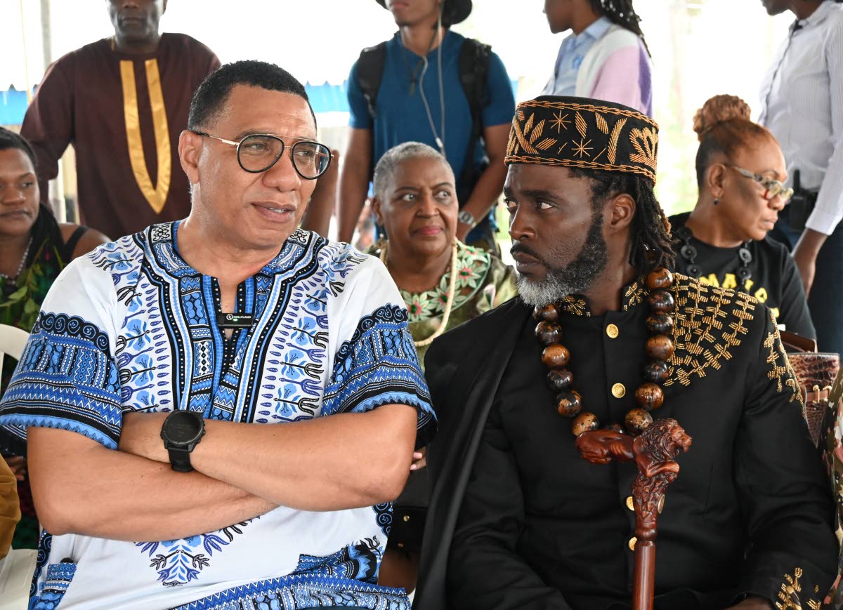 Prime Minister Dr Andrew Holness (left) and Chief of Accompong Richard Currie in conversation at the 288 Maroon Treaty celebration in Accompong Town, St Elizabeth, on Tuesday.