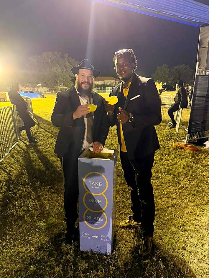 Rabbi Raskin (left) is sharing the ARK Box, Acts of Routine Kindness, (which encourages individuals to give locally and build a daily habit of kindness), presented to superstar Ozarri.