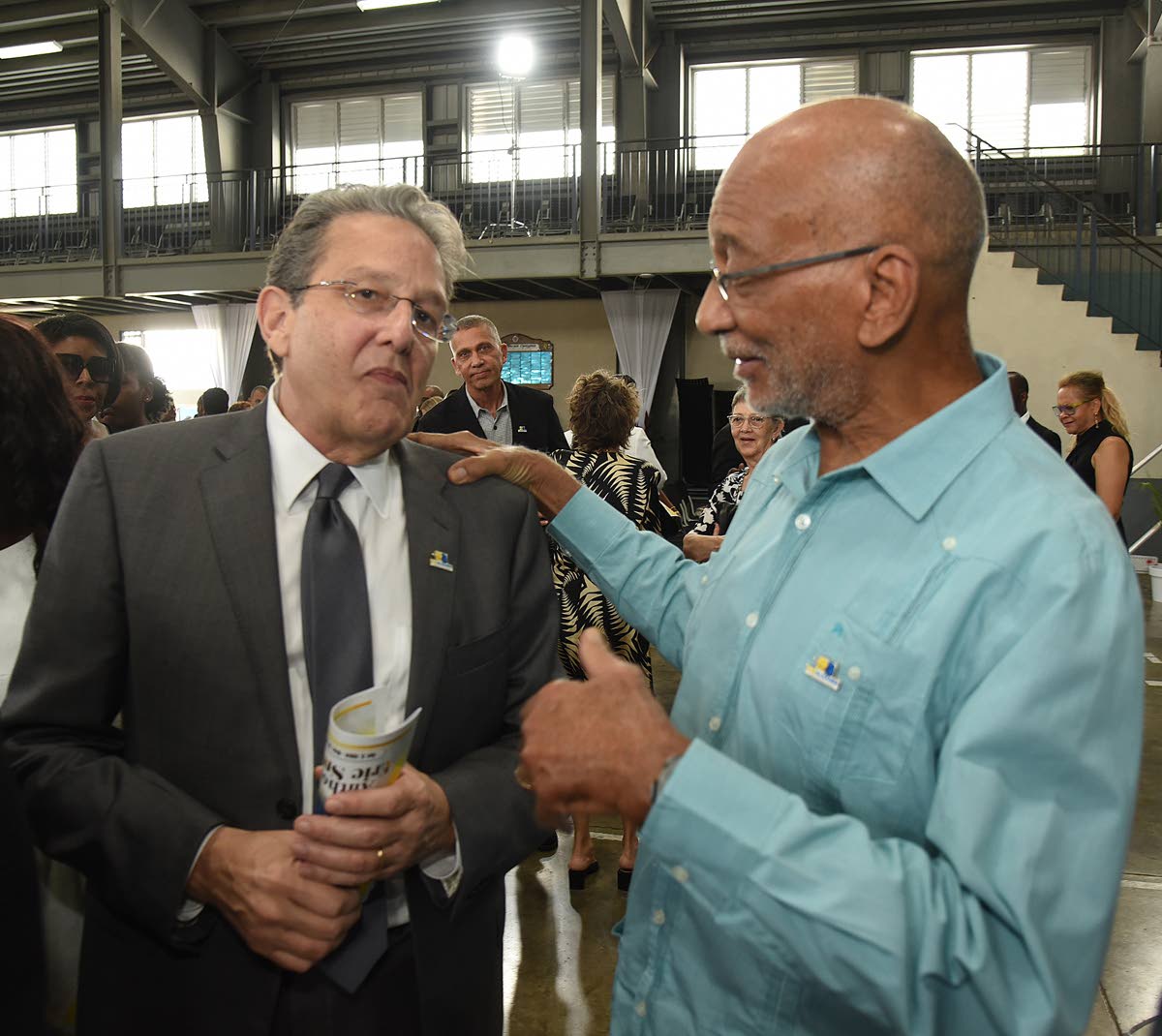 Joseph M. Matalon (left), executive chairman of the RJRGLEANER Communications Group, gives a listening ear to Douglas Orane, board member of the group, during yesterday’s thanksgiving service for the liife of Anthony Smith.