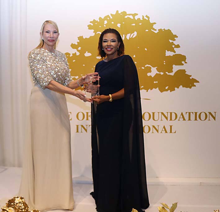 Minister in the Office of the Prime Minister with responsibility for Efficiency, Innovation and Digital Transformation, Ambassador Audrey Marks receives the 2026 Golden Heart Award from Tree of Life Foundation President Amanda Schumacher.