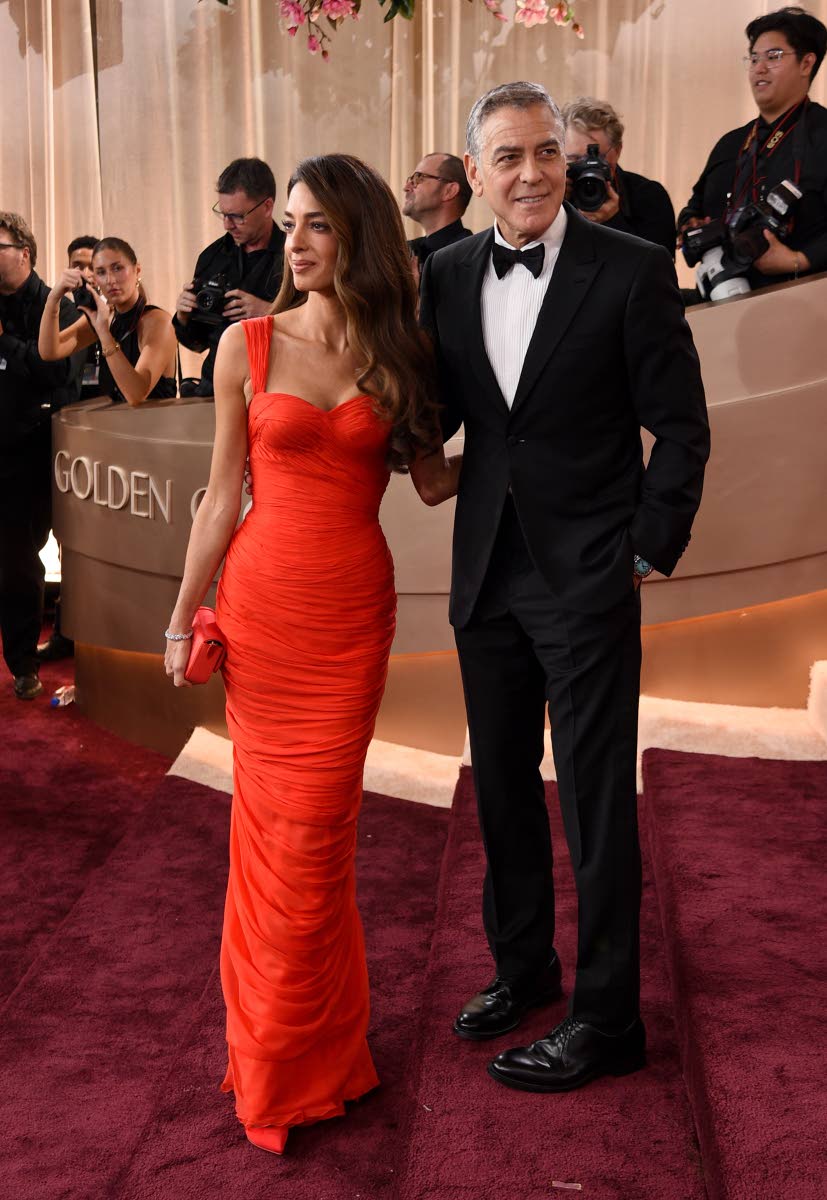 Amal Clooney (left) and George Clooney arrive at the 83rd Golden Globes on Sunday, at the Beverly Hilton in Beverly Hills, California, Amal in vintage French luxury brand Balmain, and George in Giorgio Armani. 