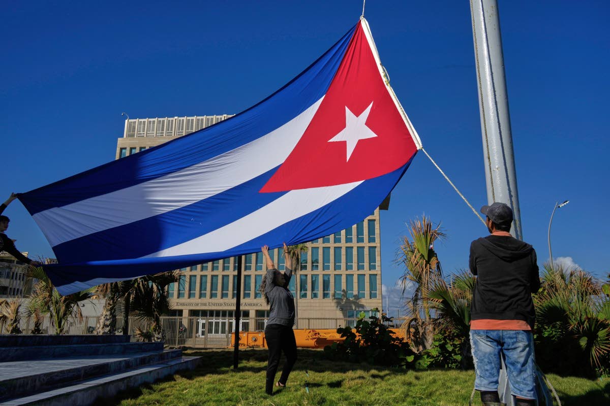 Workers fly the Cuban flag at half-staff at the Anti-Imperialist Tribune near the US Embassy in Havana, Cuba on January 5, 2026, in memory of Cubans who died two days before in Caracas, Venezuela during the capture of Venezuelan President Nicolas Maduro by