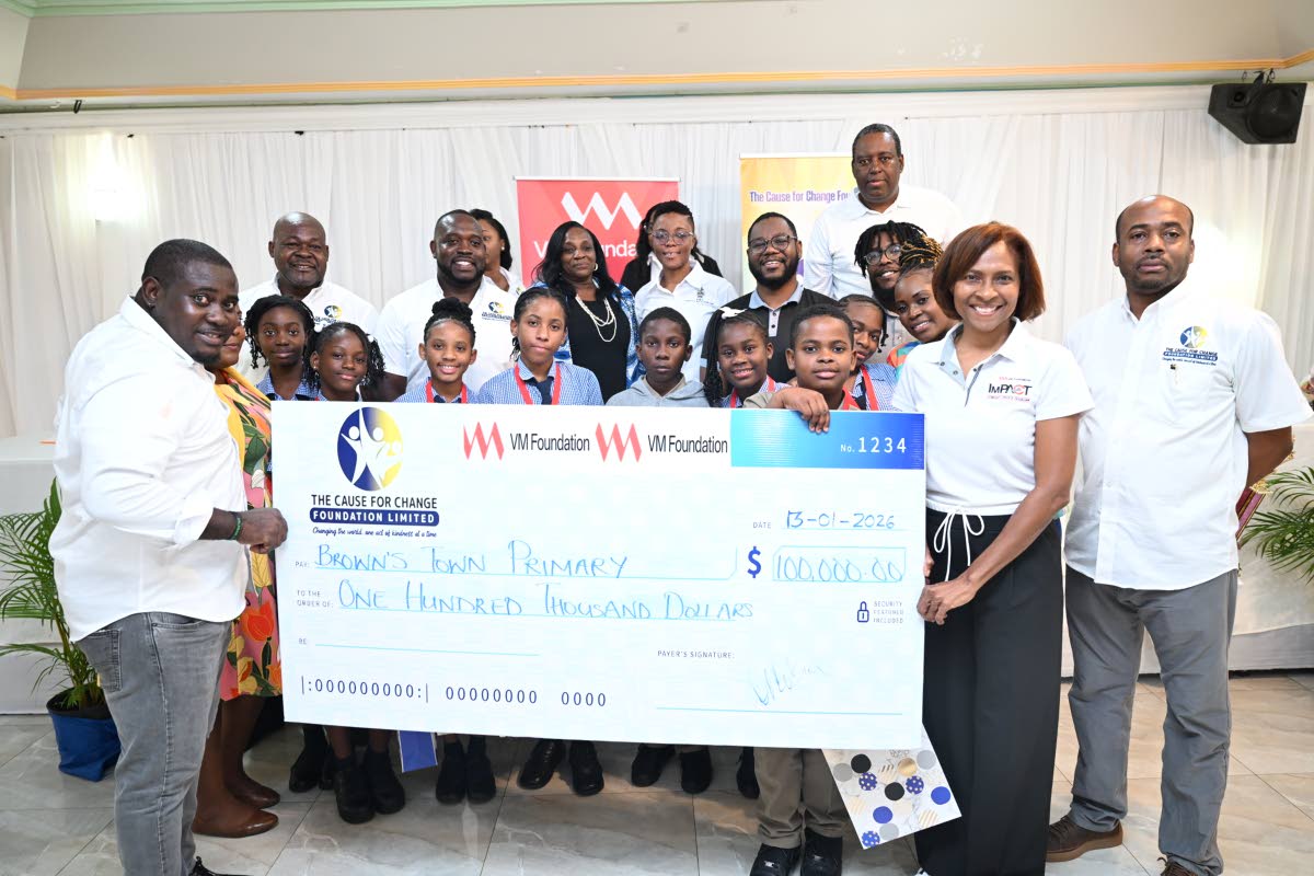 Principal director of Cause for Change Foundation Limited, Richardo Aiken (left), and CEO of VM Foundation, Samantha Charles (second right), present the winning cheque to students of Brown’s Town Primary who won the finals of the Environmental Quiz and E