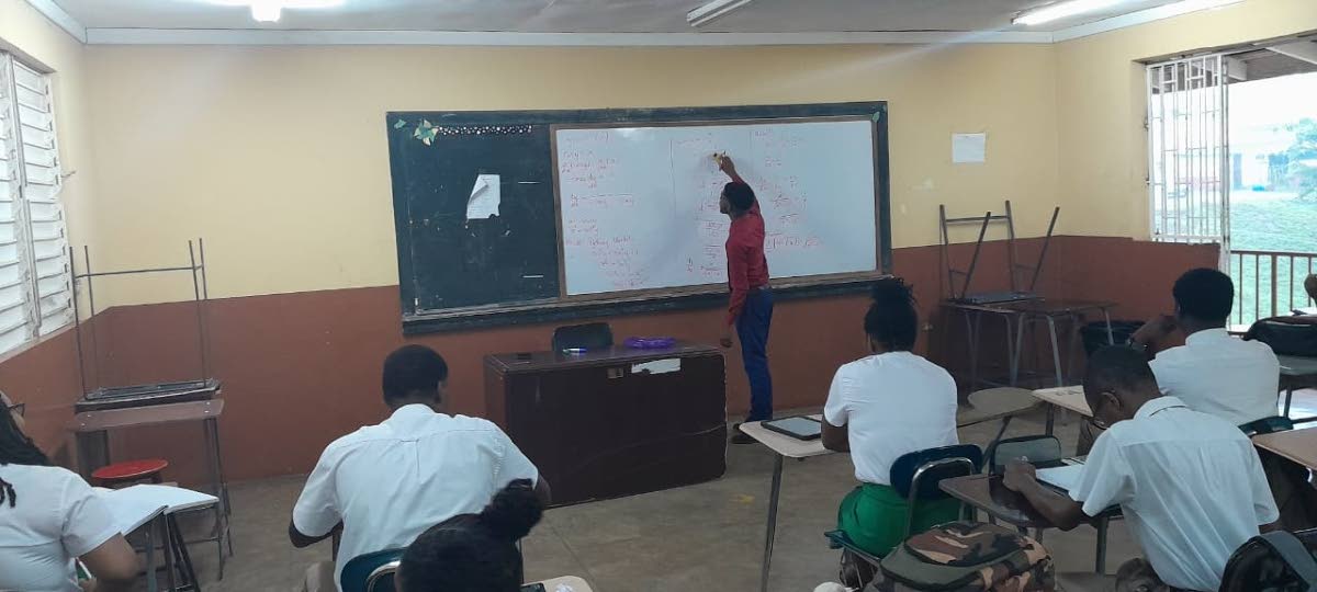 Denvor Green working as a teacher at Manchester High School.