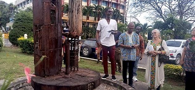 From left: Phillip Clarke, director of UTech’s Centre for the Arts, speaks to the gathering about one of Mazola’s sculptures in the Sculpture Park.