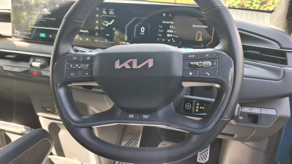 The four-spoke steering wheel feels substantial in hand, cleverly integrating drive mode selectors and the illuminated Kia emblem for a cockpit that feels more like a command centre.