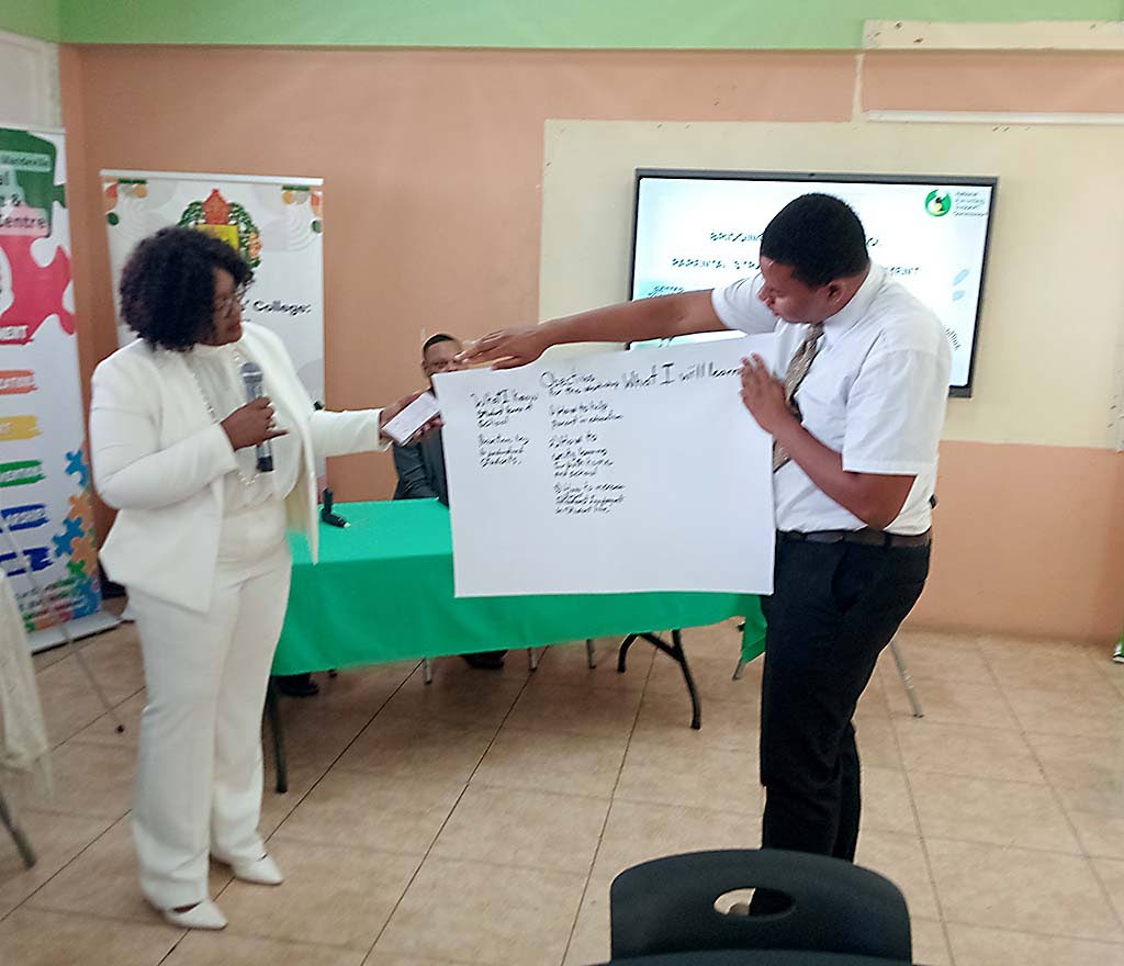 Kaysia Kerr (left), chief executive officer of the National Parenting Support Commission (NPSC),  looks on as Kyle Paul Stephenson (right) explains to the audience the objectives he hopes to be achieved by the end of the workshop.