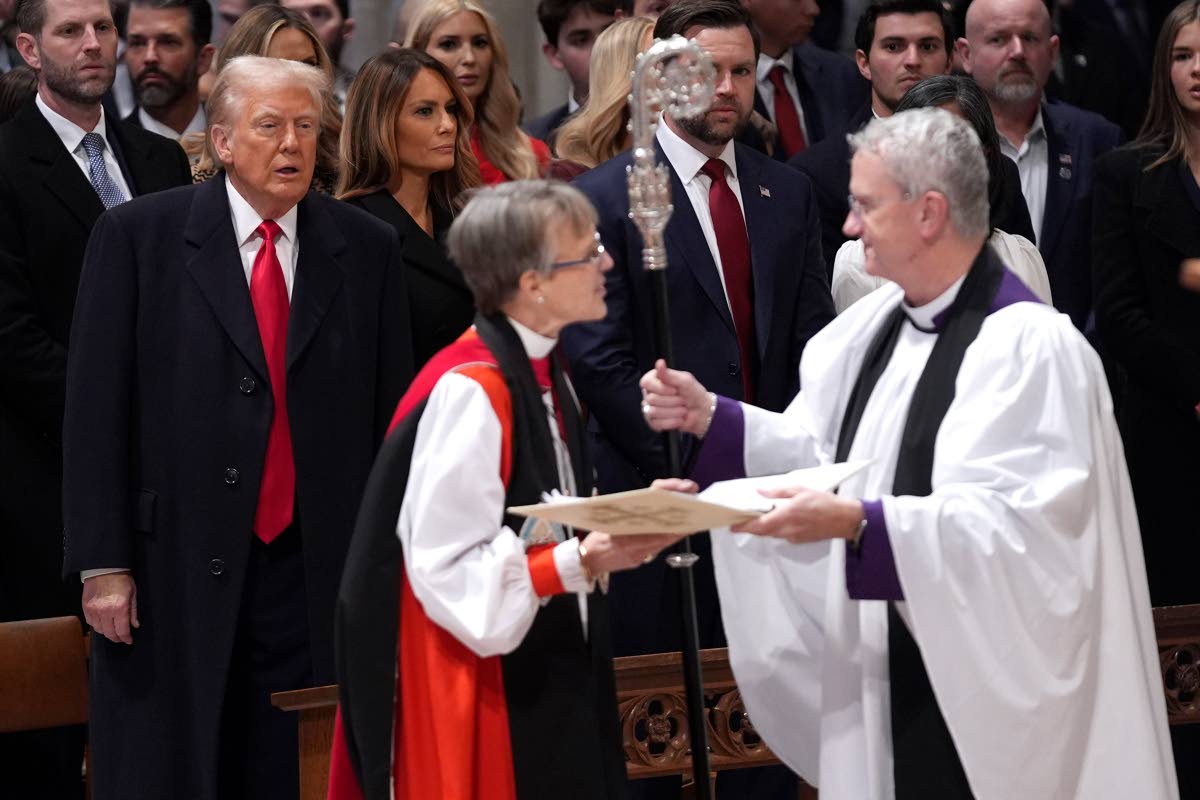 President Donald Trump  watches as Rev Mariann Budde arrives at the national prayer service at the Washington National Cathedral, on Tuesday, January 21, 2025 in Washington. 