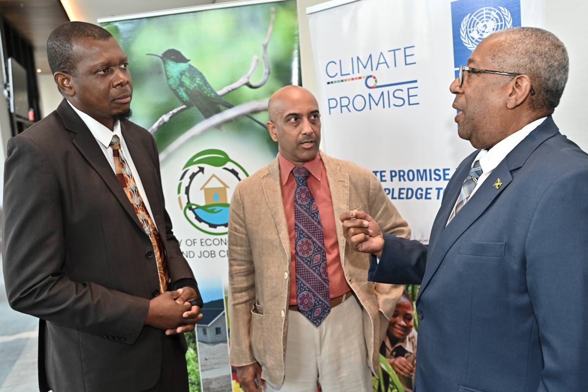 Ambassador Dale Webber (right), special envoy for climate change, environment, ocean and blue economy, speaks with (from left) Omar Alcock, Climate Change Division of the Ministry of Economic Growth and Job Creation; and Khoday at Jamaica’s National COP3