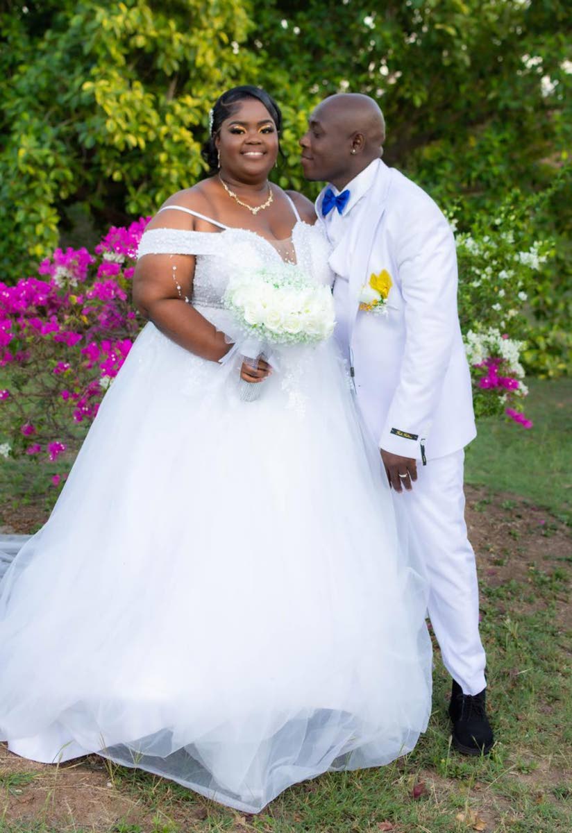 Iswall leans in to kiss his beloved, while Keisha shines in her off the shoulder fit and flare wedding dress from Unions Bridal Boutique.