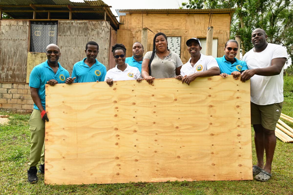 From left: Loflin Jackson, Desmond Douglas, Andrea Pryce and O’Neil Pryce, Bunkers Hill resident Tanekia Titus, Simone Walters and community representative Courtney McIntosh pose for the camera. Pictured in the back row is Akintola Daley.