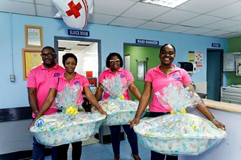 JDF Credit Union staff prepare to deliver care baskets at the Victoria Jubilee Hospital, providing practical support to first-time mothers for Mother’s Day.