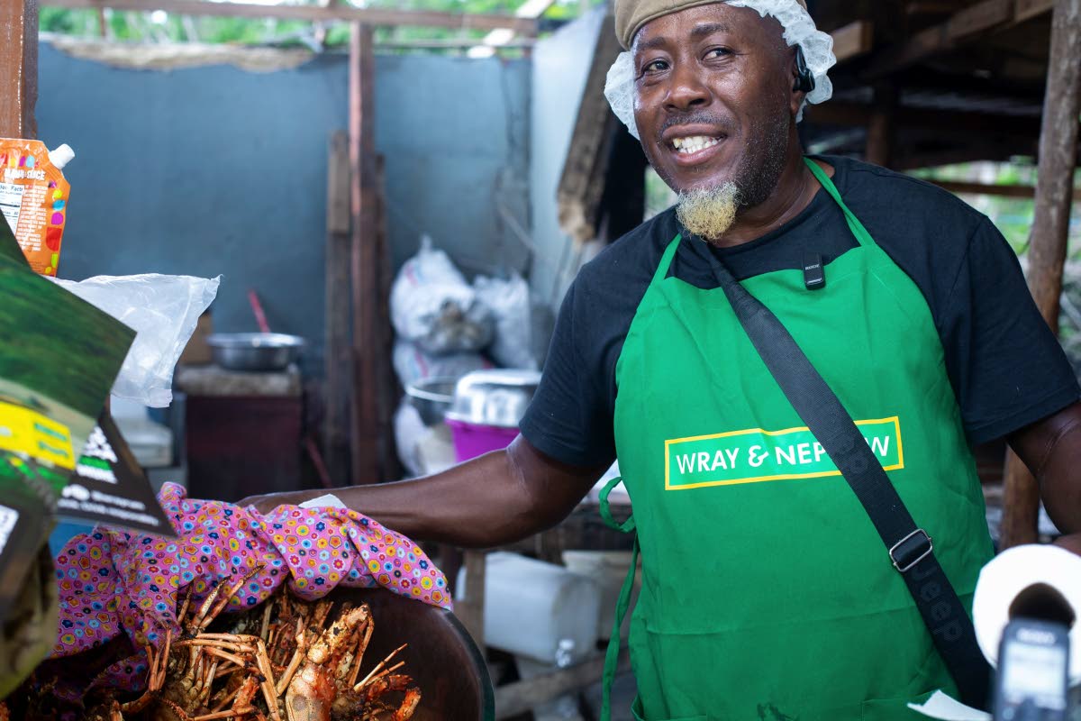 Popular vendor Coolie Man displays his much-talked-about French-fried lobster. 