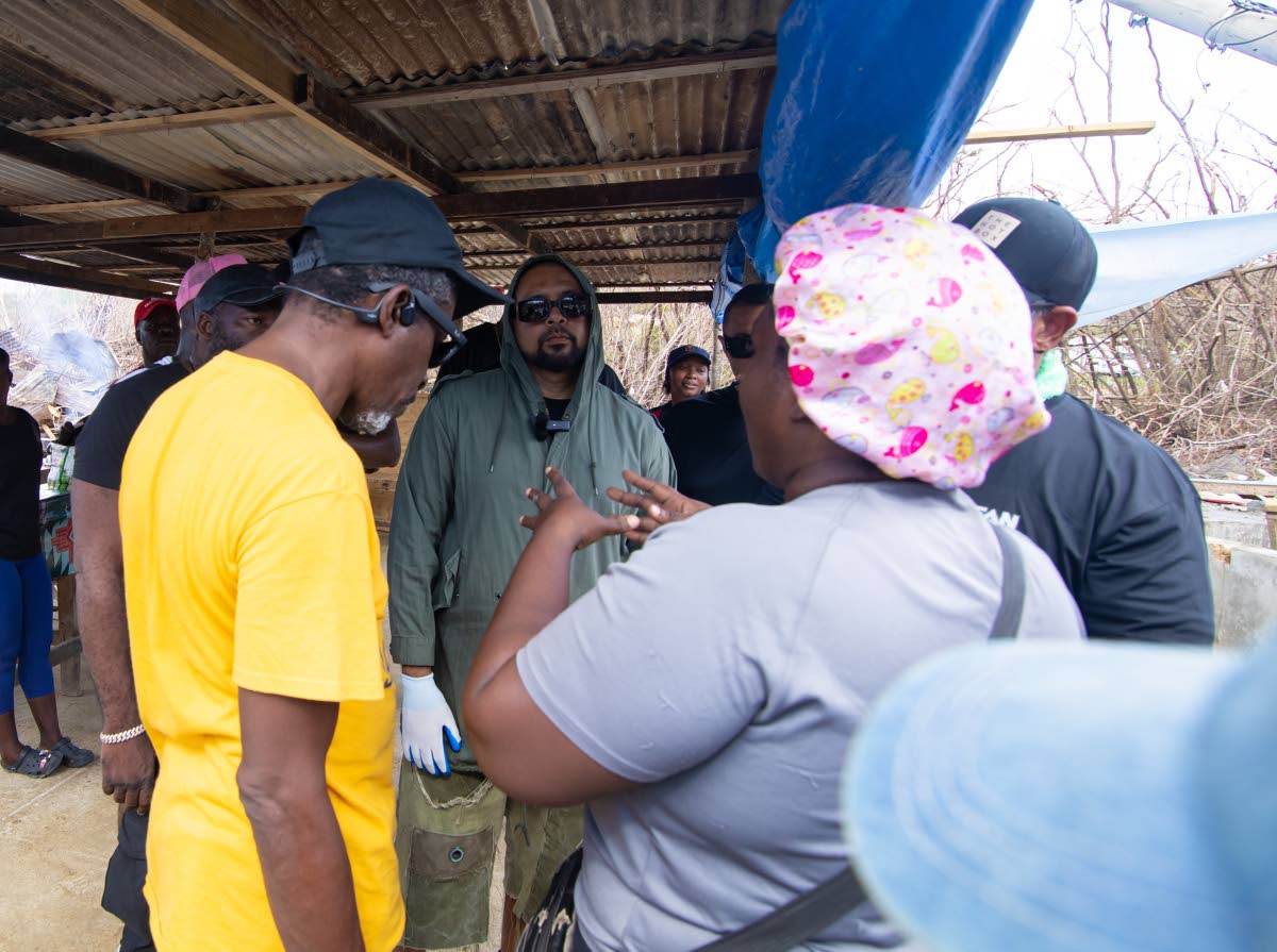 International dancehall artiste Sean Paul  (facing camera in glasses) and members of the Sean Paul Foundation team engage in preliminary discussions with vendors at Border following the passing of Hurricane Melissa. 
