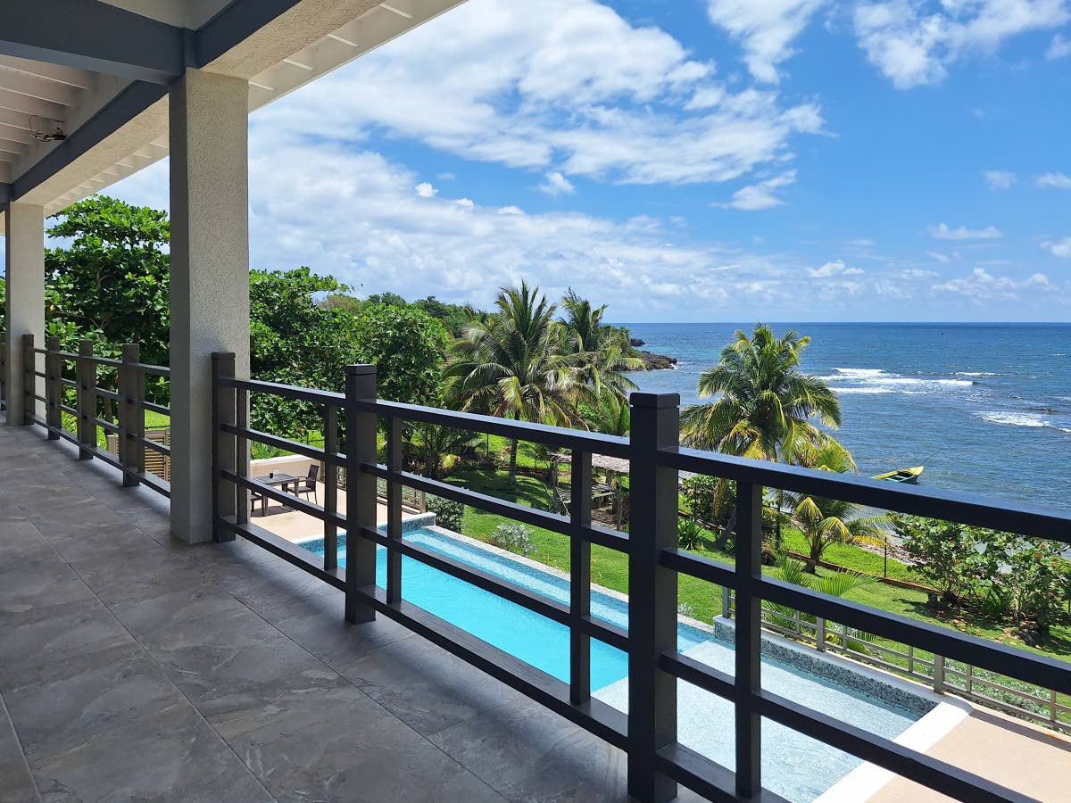 Look out to scenic views from the villa’s full-length balcony.