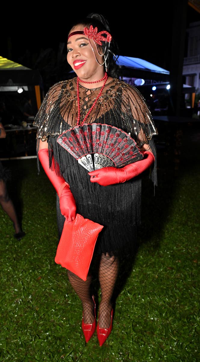 Jodie-Ann Wilson, business officer, channels Gatsby-era glam in black and red.