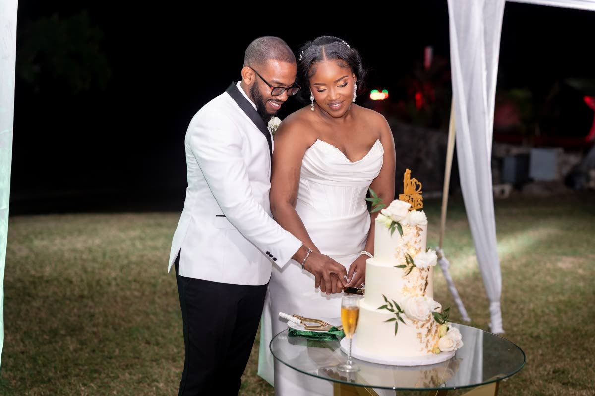 Smiles all around as the newly-weds prepared to share their first bite as husband and wife.