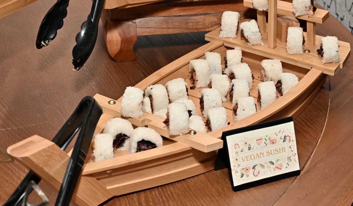 The vegan sushi is a selection of fresh vegetables assembled into neatly rolled sushi, highlighting texture and freshness.  