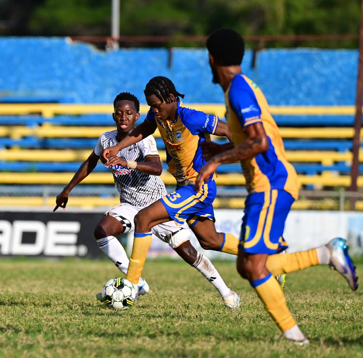 Harbour View’s Dontaye Omar-David Mullings (centre) dribbles away from Cavalier’s Dwayne Allen during a Jamaica Premier League football match at the Harbour View Mini-Stadium in December of 2025. Looking on is Harbour View’s Rohan Brown.