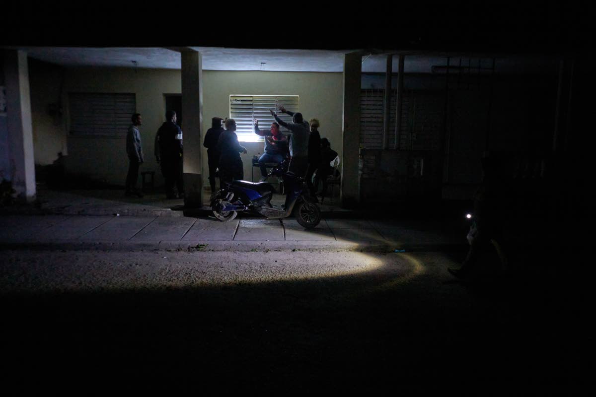 People celebrate a birthday during a scheduled power outage in Santa Cruz del Norte, home to one of Cuba’s largest thermoelectric plants.