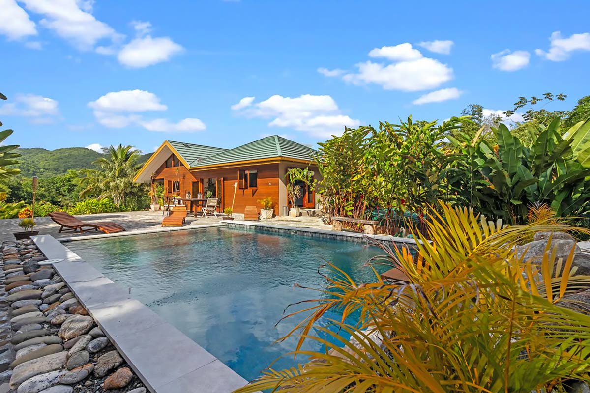 The pool, which features waterfalls, is bordered by river stones.