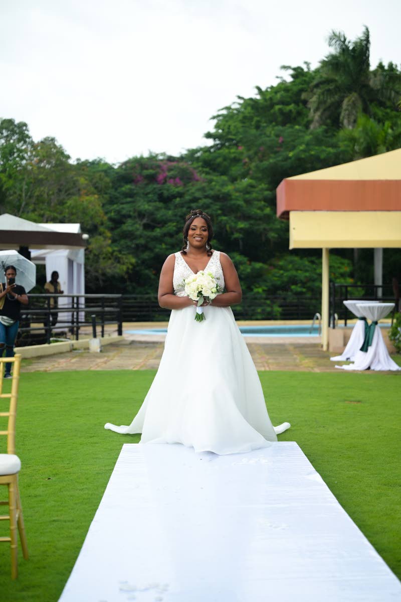 Antoinette wore the Chelsea dress by Eddy K Bridal, crafted from beaded lace over champagne chantilly lace, with organza layers, pockets, and a buttoned train.
