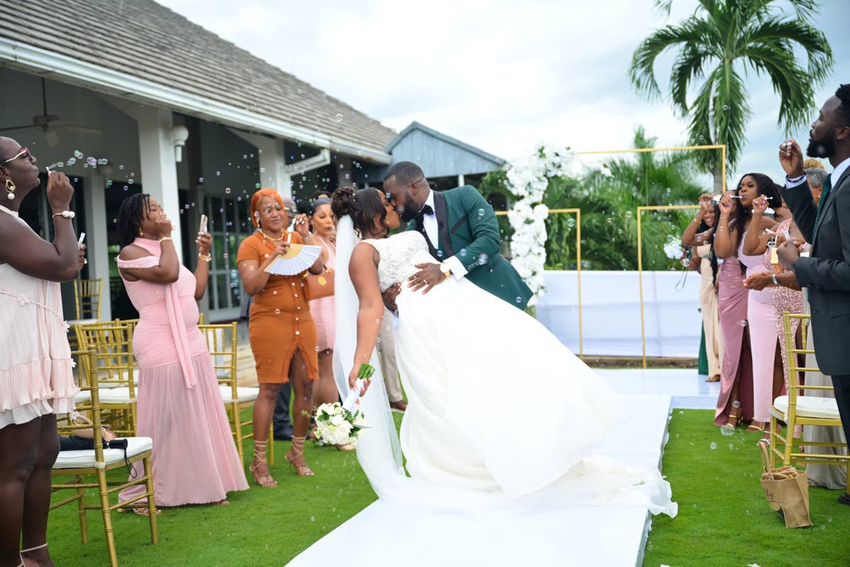 A playful dip and a sweet kiss sealed the moment for the newly-weds, marking the start of their life together as husband and wife.