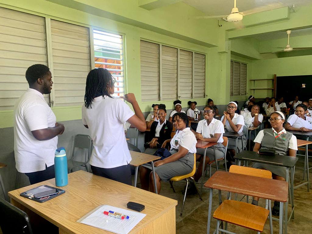 National General Secretary Jordan Forrester and National President Nashá Patterson having discussions with the prefecture of Montego Bay High School for Girls in St James. 