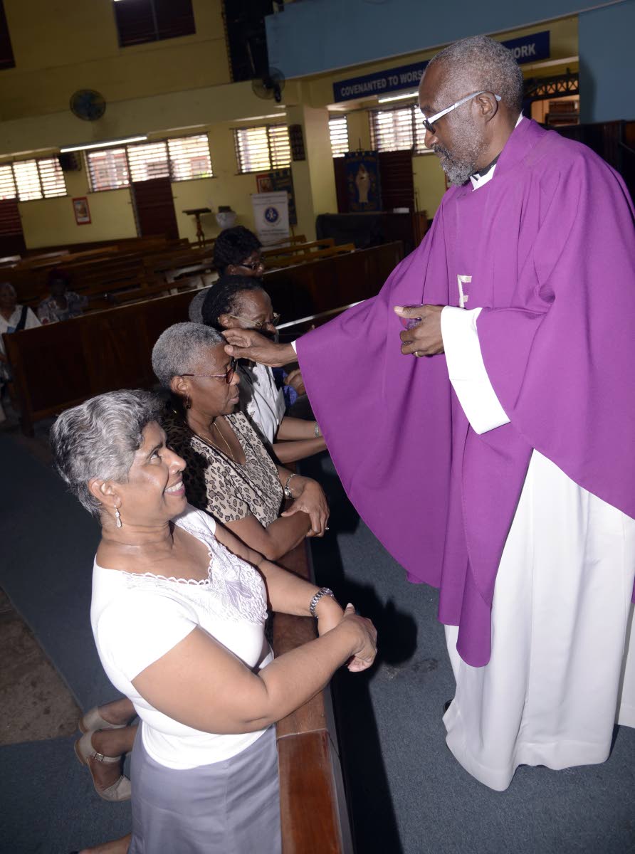 Ven Patrick Cunningham, of St Luke’s church St Andrew, rubbed ash on the forehead of members on  Ash Wednesday, a day of fasting, and the first day of Lent.