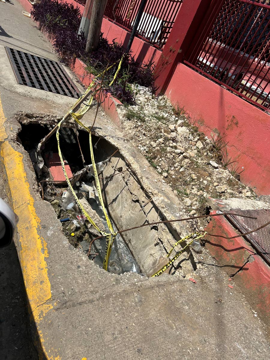 A section of the collapsed sidewalk with protruding steel along Lewis Street in Savanna-la-Mar, Westmoreland.