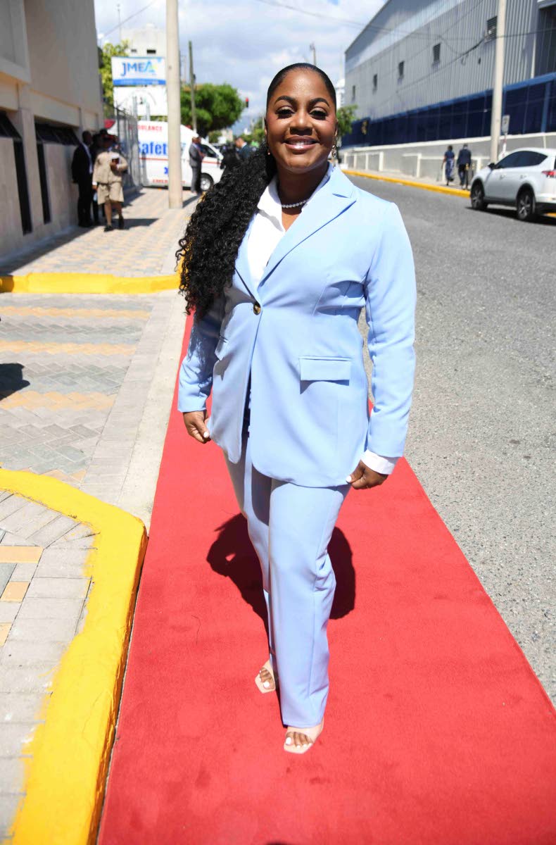 Walking the red carpet in a baby-blue suit is former councillor Kari Douglas, who is also a real estate dealer, valuation surveyor, and chief executive officer of Easton Douglas Consultants Limited. 