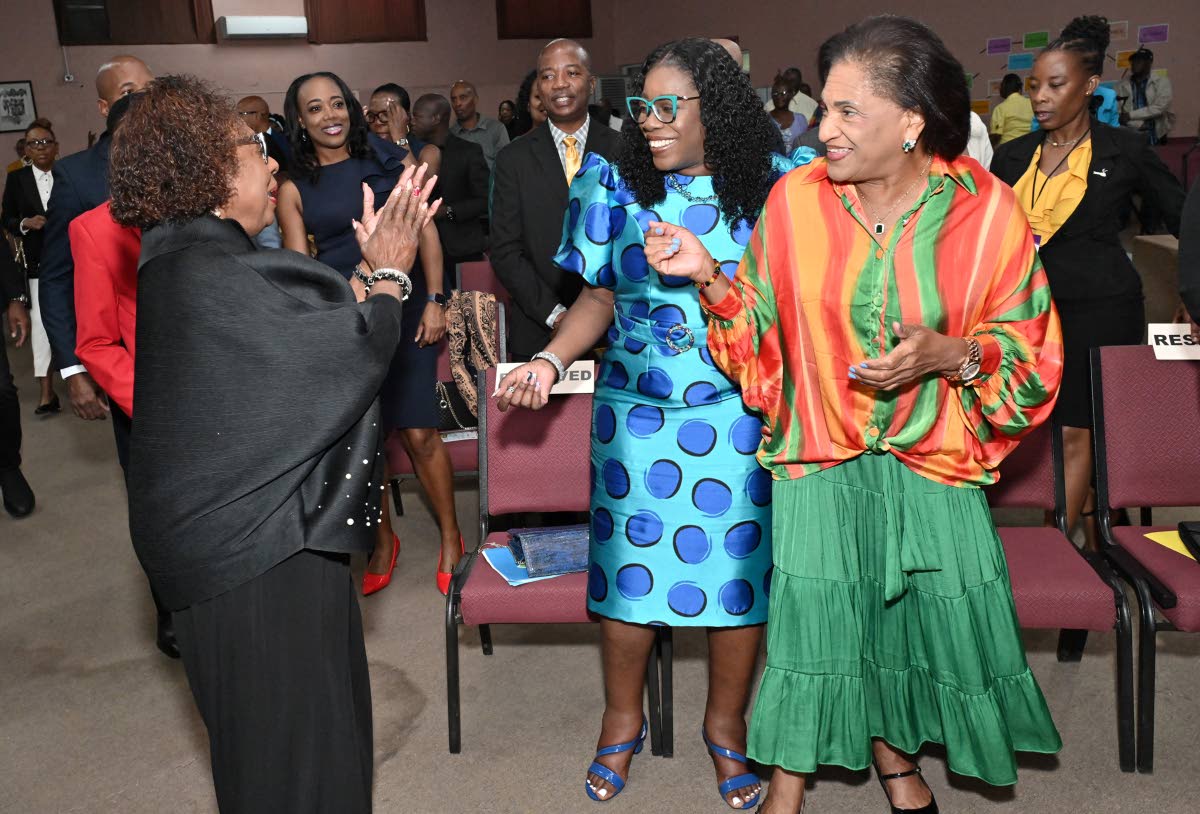 Minister of Culture, Gender, Entertainment and Sport, Olivia Grange (left) dances with Director of Tourism Linkages Network Carolyn McDonald-Riley, (centre) and Executive Director, Joy Roberts at the Reggae Month Church Service.
