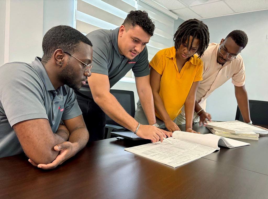 MEP coordination review by designers (from left): Dwight Simpson (electrical), Spencer Logan (electrical), Shenelle Tyrell (mechanical), and Josh Walters (electrical).
