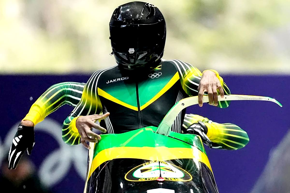 Jamaica’s Shane Pitter (front) and Junior Harris start for a two-man bobsled run at the 2026 Winter Olympics, in Cortina d’Ampezzo, Italy, on Monday.