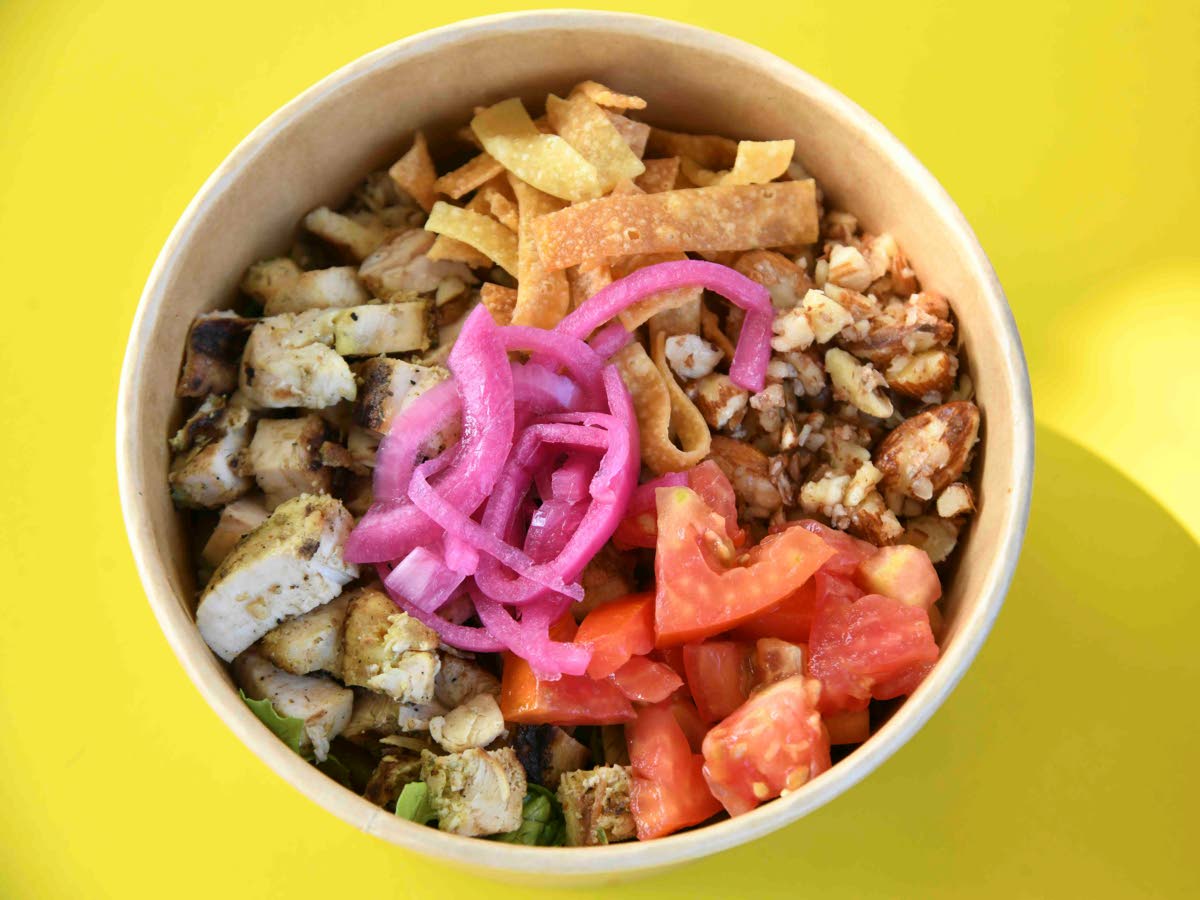 This crunch bowl is a combination of a signature salad blend, grilled chicken, pickled red onion, grape tomatoes, candied almonds and crispy wonton chips, topped with a mango vinaigrette.