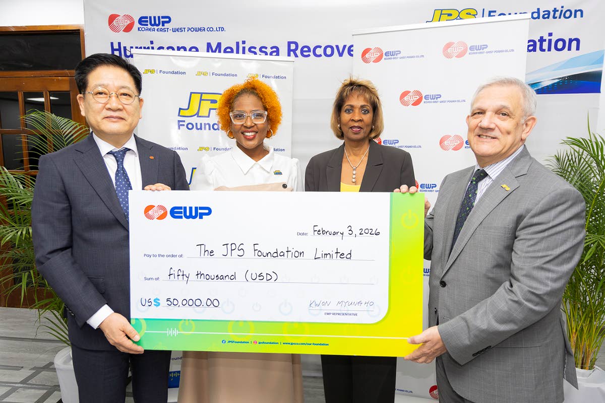 Charmaine Heslop-DaCosta (second right), senior vice president, People Operations, Jamaica Public Service (JPS), and Sophia Lewis (second left), Head, JPS Foundation, stand with Myung Ho Kwon (left), chief executive officer, EWP, and Damian Obiglio (right)