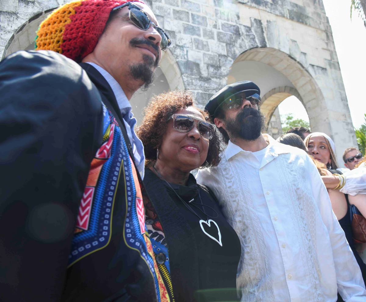 From left: Shiah Coore, son of Cat Coore, poses with Olivia Grange, minister of culture, gender, entertainment and sport, and reggae artiste, Damian Marley.