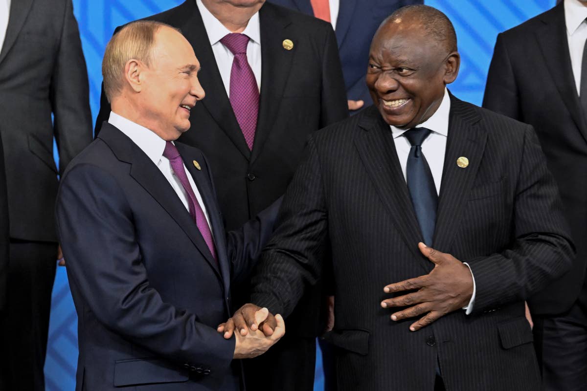 Russian President Vladimir Putin (left) and South African President Cyril Ramaphosa shake hands during a family photo ceremony prior to Outreach/BRICS Plus format session at BRICS Summit in Kazan, Russia, Thursday, October 24, 2024. 