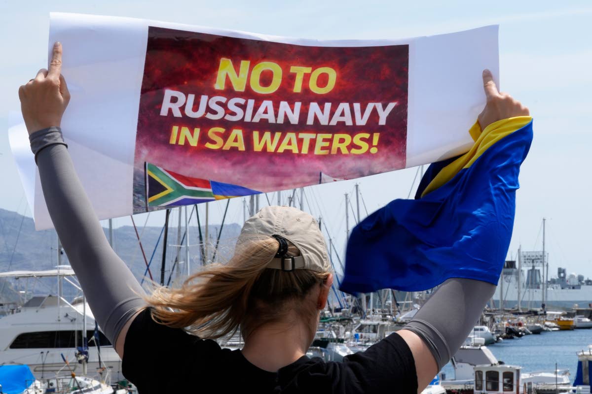 A protester demonstrates against Russia’s naval presence in Simon’s Town Harbour in Cape Town, South Africa, Friday, Jan. 9, 2026. 